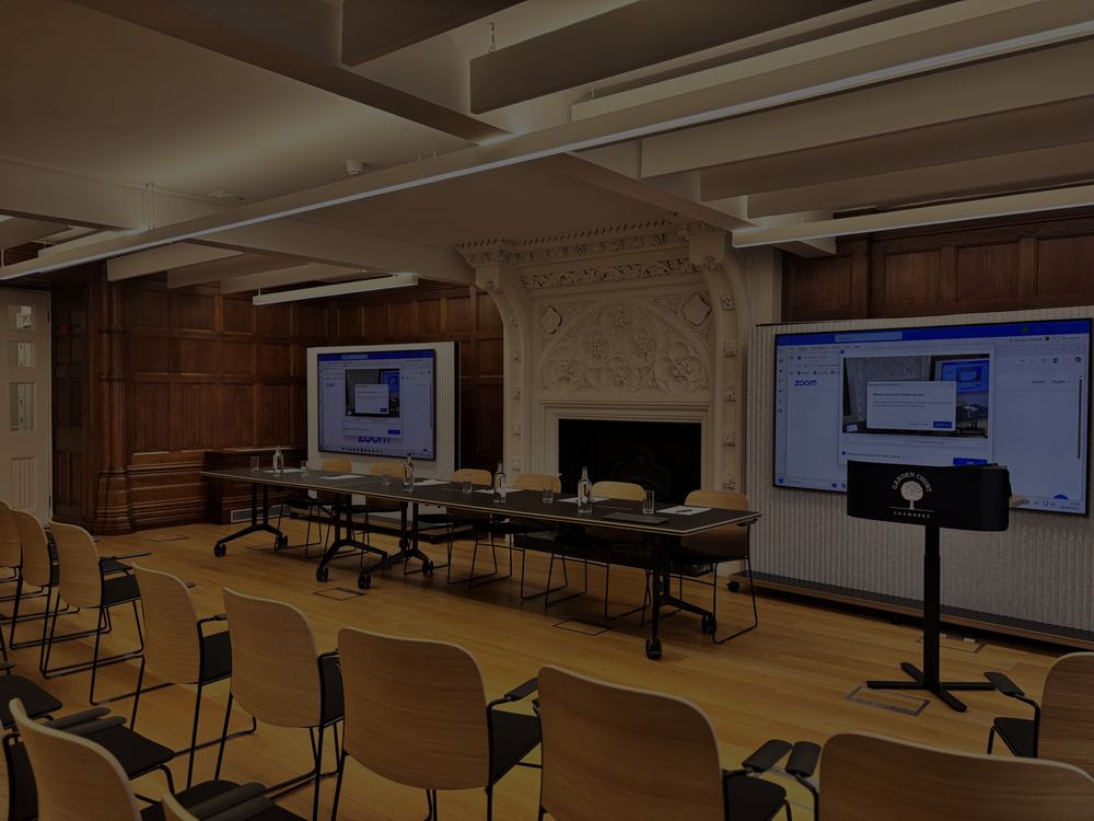 Wood-panelled room at Garden Court Chambers with displays, conference tables and a fireplace