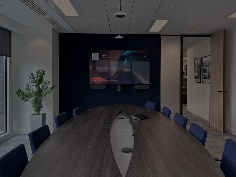 Gridworks meeting room with a wall display above a long boardroom table