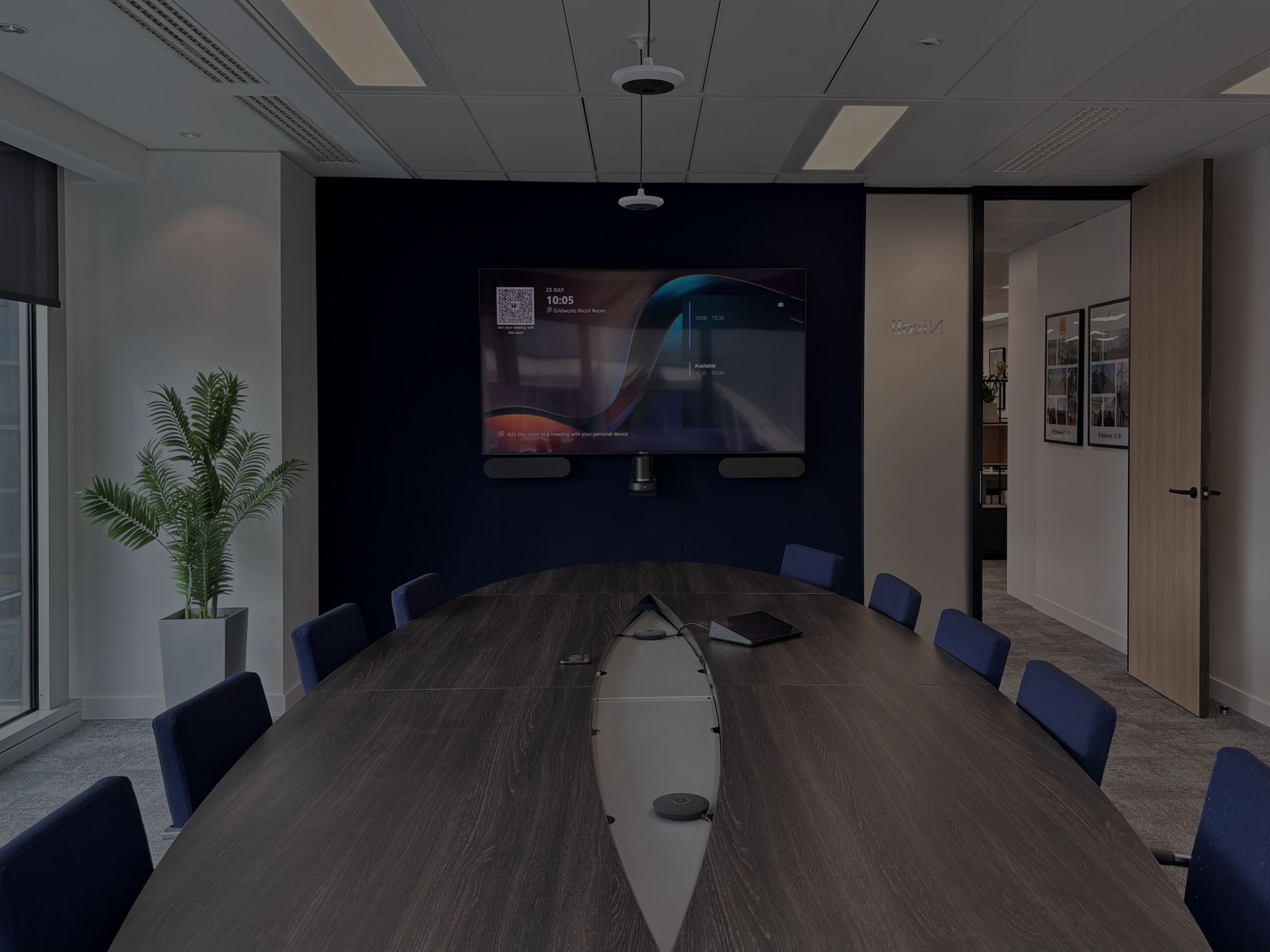 Gridworks meeting room with a wall display above a long boardroom table