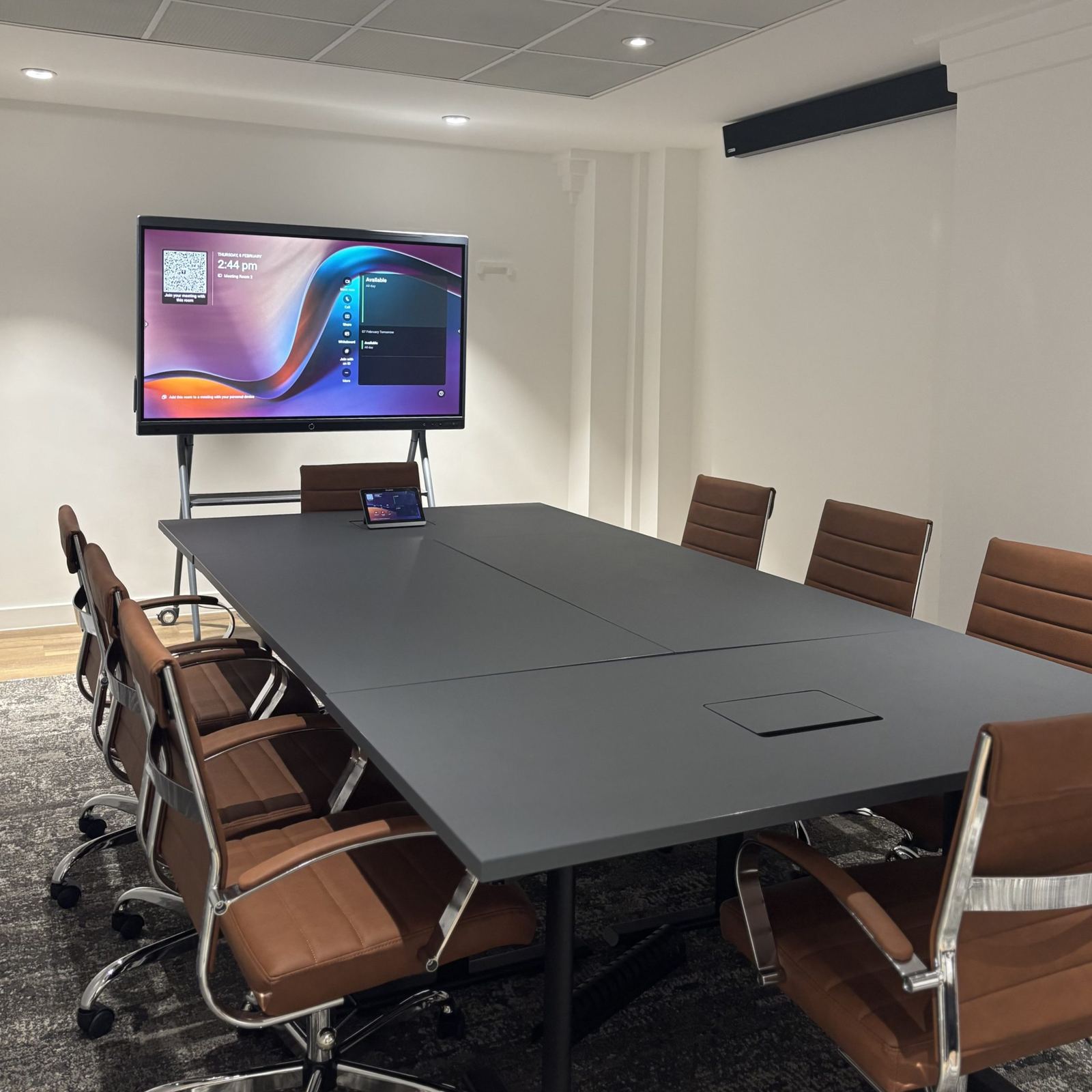 MFB Solicitors meeting room with a display on a floor stand and a grey table