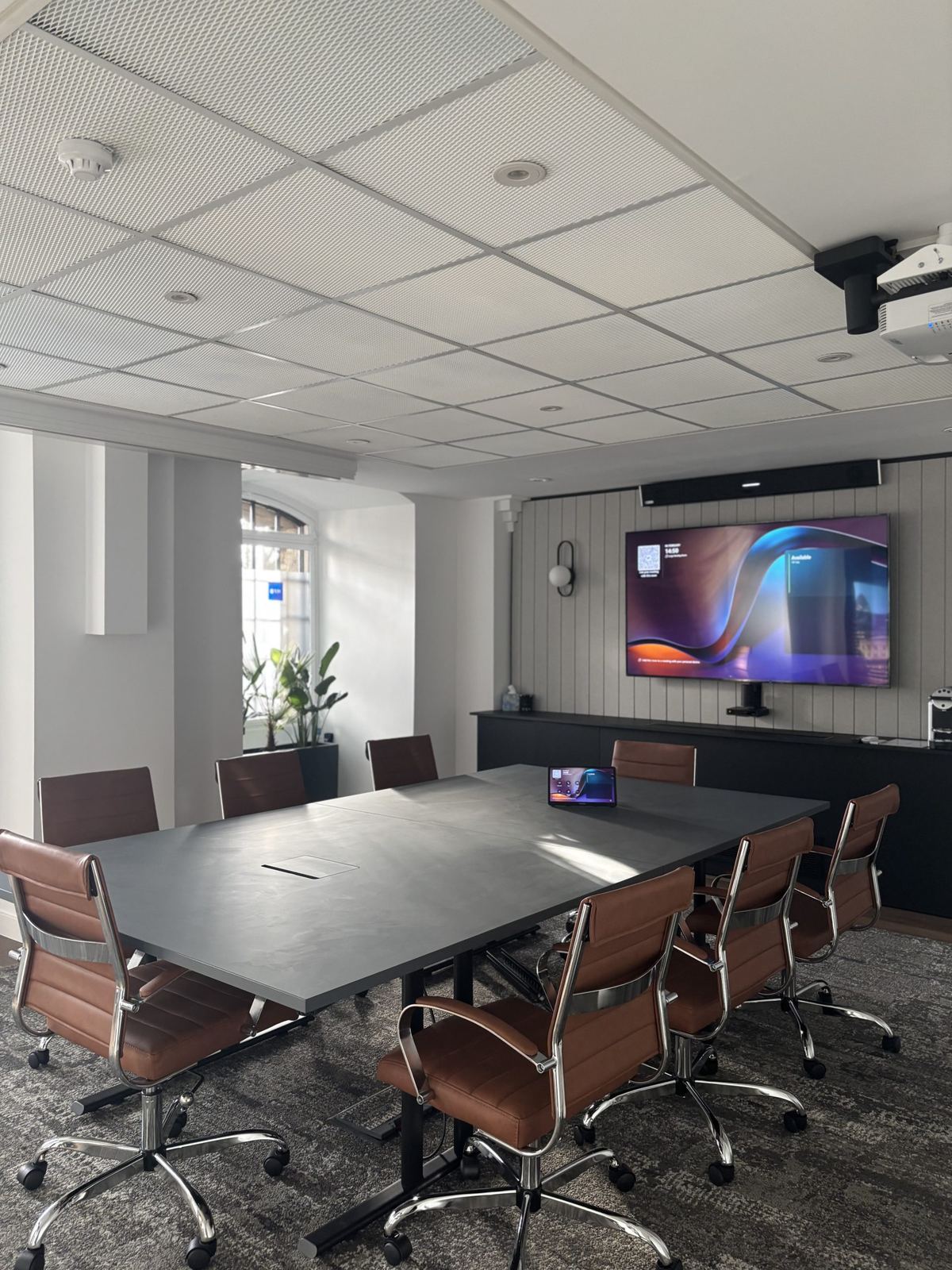 MFB Solicitors meeting room with a wall display and long table
