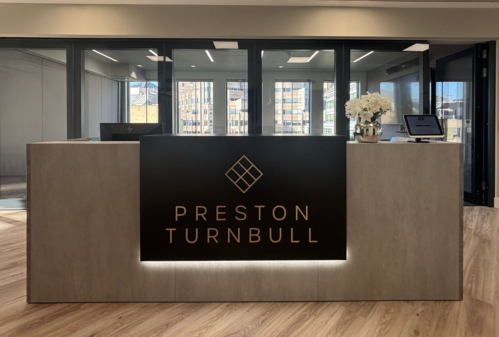 Preston Turnbull reception desk with illuminated logo