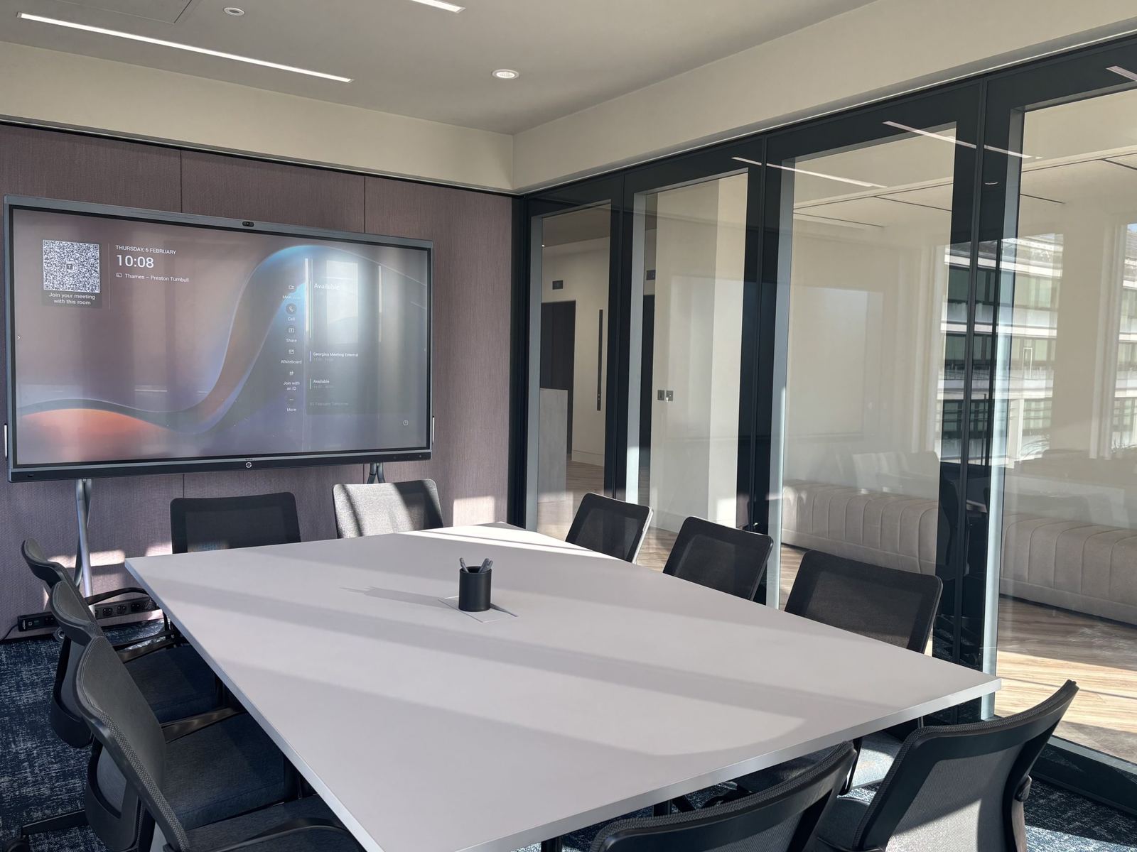 Preston Turnbull meeting room with a wide interactive display and white table