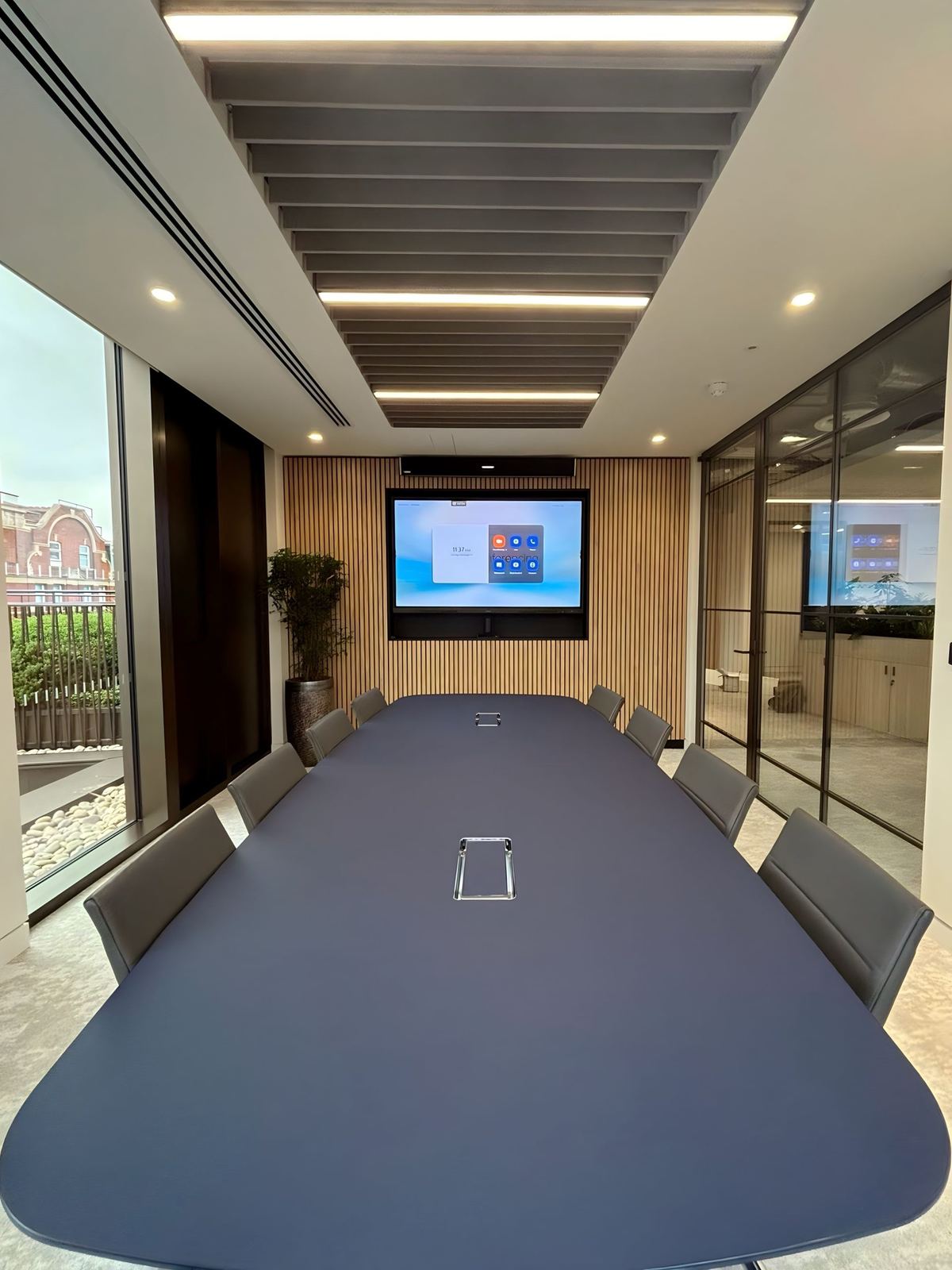 VR Capital meeting room with a long table and wall-mounted display