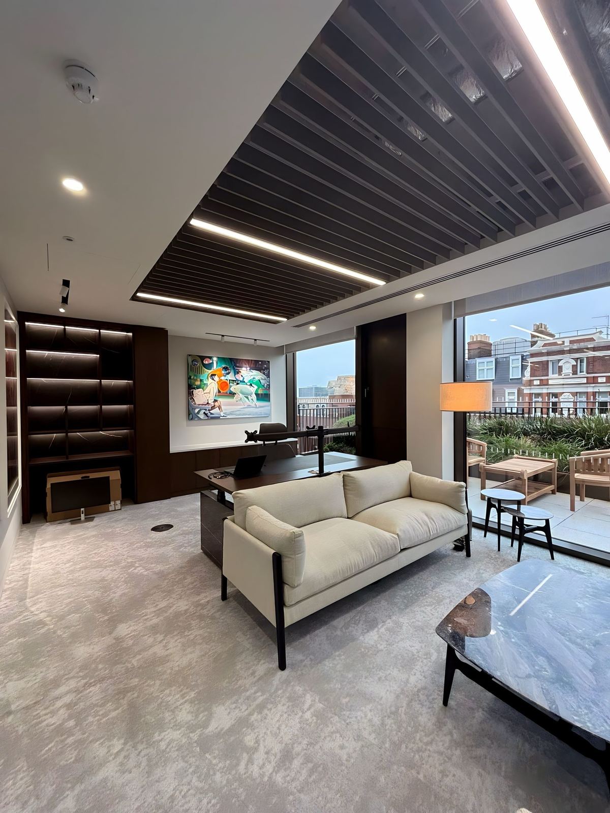 VR Capital lounge area with sofas, slatted ceiling and large windows